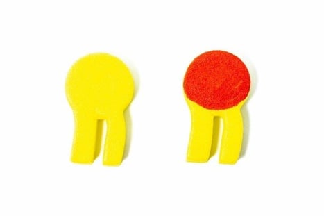 Two models of phospholipids with a round head and two tails, or legs. One model is all yellow. The other has a circle around the head that has been colored in red.
